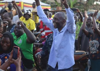 Luttamaguzi leaves the function under police escort as his supporters cheer him.