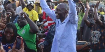 Luttamaguzi leaves the function under police escort as his supporters cheer him.