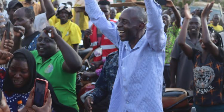 Luttamaguzi leaves the function under police escort as his supporters cheer him.