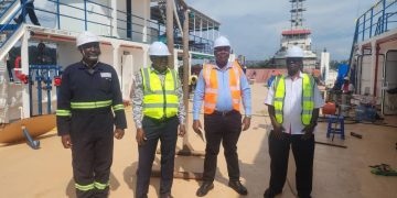 Capt. Alexander Tuhoye (black overall), Mr Joseph Mulindwa, Eng. JB Lubega and Prof. John Ssenfuma.