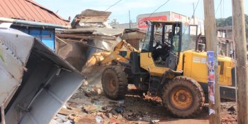 Authorities carry out an early morning demolition of roadside kiosks in Kikooza, Mukono Municipality, as part of an enforcement operation to clear illegal structures from road reserves.