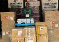 SASCELLS official displays a newly received consignment set for distribution to intended beneficiaries.