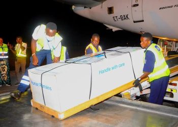 State Minister for Youth and Children Affairs Balaam Barugahara and family members receive the body of Timothy Muganzi Magambo, son of CID Director Tom Magambo, upon arrival at Entebbe International Airport on Tuesday morning.