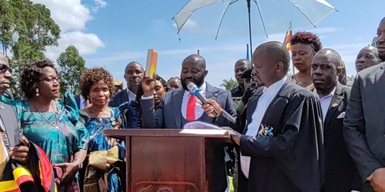 Ronald Kasekende takes oath of office during the swearing-in ceremony for newly elected leaders at Sport Arena Grounds in Kitovu, Masaka City.