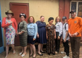 Stakeholders and disability rights activists pose for a group photo after addressing the media in Kampala