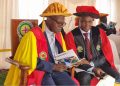 Rev. Fr. Prof. John Chrysotom Maviiri shares a moment with Peter Kiwanuka Bbosa during the 13th graduation ceremony