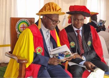 Rev. Fr. Prof. John Chrysotom Maviiri shares a moment with Peter Kiwanuka Bbosa during the 13th graduation ceremony