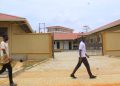 Students of St Kizito Technical Institute Kitovu walking past the new workshop built by government