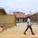 Students of St Kizito Technical Institute Kitovu walking past the new workshop built by government