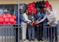 Dorothy Ssemanda is joined by Rodrigo Jimenez and Sam Mwogeza to cut ribbon as a they launch the Katwe Noor Digital Community