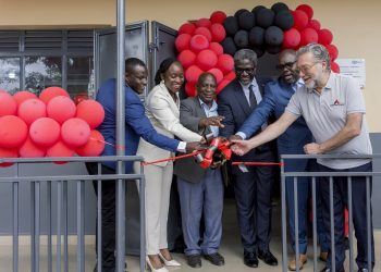 Dorothy Ssemanda is joined by Rodrigo Jimenez and Sam Mwogeza to cut ribbon as a they launch the Katwe Noor Digital Community