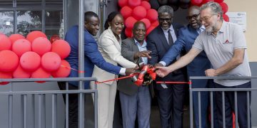 Dorothy Ssemanda is joined by Rodrigo Jimenez and Sam Mwogeza to cut ribbon as a they launch the Katwe Noor Digital Community