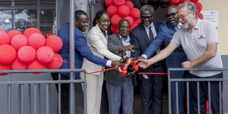Dorothy Ssemanda is joined by Rodrigo Jimenez and Sam Mwogeza to cut ribbon as a they launch the Katwe Noor Digital Community
