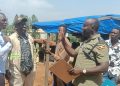 Officer in Charge of Namanve Police Station, ASP Geoffrey Tasobya, engaging and urging residents of Kolo-Buwanyi Village in Goma Sub-county, Mukono District to remain calm and allow dialogue following a standoff over Standard Gauge Railway survey equipment.