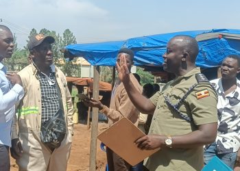 Officer in Charge of Namanve Police Station, ASP Geoffrey Tasobya, engaging and urging residents of Kolo-Buwanyi Village in Goma Sub-county, Mukono District to remain calm and allow dialogue following a standoff over Standard Gauge Railway survey equipment.