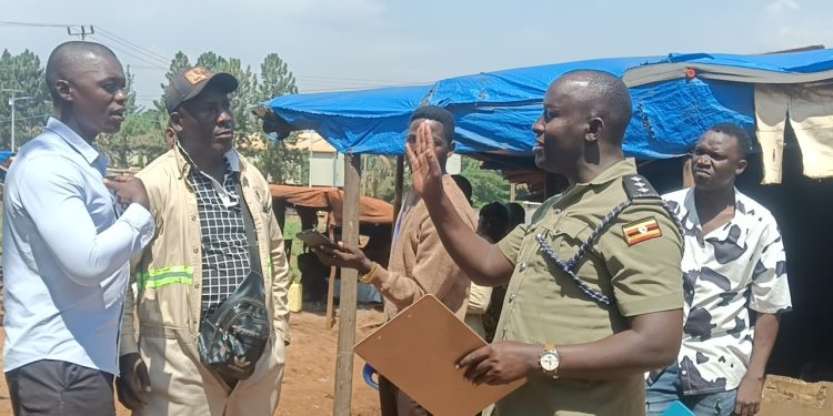Officer in Charge of Namanve Police Station, ASP Geoffrey Tasobya, engaging and urging residents of Kolo-Buwanyi Village in Goma Sub-county, Mukono District to remain calm and allow dialogue following a standoff over Standard Gauge Railway survey equipment.