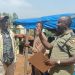 Officer in Charge of Namanve Police Station, ASP Geoffrey Tasobya, engaging and urging residents of Kolo-Buwanyi Village in Goma Sub-county, Mukono District to remain calm and allow dialogue following a standoff over Standard Gauge Railway survey equipment.