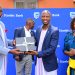 Stephen Segujja (R) Head, Economic Enterprise Restart Fund (EERF) and Cathering Poran, the CE Stanbic Business Incubator handing over a gift to the Rt. Hon. Joseph Muvawala the Prime Minister of Busoga Kin