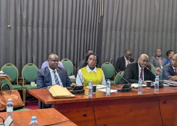 150 Local Government Officials Flagged Over Alleged Mismanagement, 40 Taken To Court KAMPALA – At least 150 local government officials have been flagged over alleged mismanagement, corruption and misuse of public resources, with 40 already facing prosecution before the Anti-Corruption Court. The Minister of Local Government, Balaam Barugahara Ateenyi, disclosed the figures while appearing before Parliament’s Public Accounts Committee (Local Governments), chaired by Mukono Municipality MP Betty Nambooze. Barugahara said nine additional case files are ready for submission to court, while 24 files are still being completed and 30 others remain under investigation. He said the figures do not include cases from West Nile and Budaka. According to the Minister, the cases were uncovered during field inspections in various local governments, where officials found alleged misuse of public funds, poorly executed projects and failures in supervision. Among the cases cited was a Shs73 million pit latrine project in Mulambuli, which Barugahara said was commissioned despite lacking a proper pit. He also cited a road project where laboratory tests allegedly found no suitable murram material, despite funds having already been spent on the works. Barugahara described some of the cases as evidence of syndicated corruption, in which several officials within local government structures allegedly fail to exercise their oversight responsibilities. “We should show these people that we know what you are doing, and it shall come for you,” Barugahara told the committee, warning that the government would take a tougher stance against officials involved in corruption and mismanagement. He further disclosed that investigations into financial irregularities had so far identified activities worth about Shs9.32 billion, with another Shs10 billion linked to a separate district. He said a forensic audit is being conducted to establish the actual amount involved through physical verification of roads and other government projects. PDM Funds Under Scrutiny The committee also raised concerns over alleged corruption and mismanagement in the implementation of the Parish Development Model (PDM), citing findings contained in the Auditor General’s reports. The audit identified cases in which some beneficiaries allegedly received PDM funds more than once, while others failed to procure the required assets. The committee also cited cases involving non-existent projects and the diversion of PDM funds to activities that were not eligible for financing under the programme. Nambooze said the scale of local government operations makes it impossible for the Minister to personally supervise every district, placing greater responsibility on the Ministry’s technical leadership. She urged the Ministry to ensure that officials implicated in corruption are thoroughly investigated and, where evidence supports the allegations, prosecuted. Nambooze warned against relying solely on interdictions, saying officials can eventually return to their positions if investigations are not concluded. She also questioned why reports from District Public Accounts Committees do not consistently reach Parliament, saying this limits lawmakers’ ability to obtain a comprehensive picture of accountability failures in local governments. MPs Asked To Strengthen Oversight Minister of State for Local Government Justine Nameere called on MPs to strengthen oversight of government projects in their constituencies by regularly visiting project sites and demanding accountability from implementers. Nameere pointed to differences in the quality and cost of government-funded construction projects as evidence of weak supervision. She cited a three-storey structure in Namagunga that she said was constructed at a cost of about Shs900 million, contrasting it with another project where only a slab and a few pillars had been completed despite substantial expenditure. She said closer monitoring by elected leaders could help expose poor workmanship, inflated costs and other forms of mismanagement before public funds are lost. Nameere also raised concerns over alleged corruption within District Service Commissions, saying some job seekers have reportedly been asked to pay money in exchange for government employment. She said some families have sold property in an attempt to secure jobs for their children, only to lose their money without the promised employment. Calls For Institutional Reform Permanent Secretary in the Ministry of Local Government Ben Kumumanya said accountability failures should not be attributed to a single individual because several institutions and officials have legally mandated responsibilities. He said the Ministry needs to review the existing accountability system, restructure ineffective structures and strengthen institutions responsible for inspection, auditing and oversight. “The time for restructuring, the time for policy reform, the time for reform is now,” Kumumanya said. The committee also questioned the independence of District Public Accounts Committees. Vice Chairperson Abed Nasser Mudiobole argued that allowing district councils to appoint committees that later scrutinise the councils’ performance creates a potential conflict of interest. He proposed amendments to the Local Government Act to strengthen the independence of the committees, including a proposal for the losing political side in LC5 elections to nominate members. Staffing Gaps Hamper Oversight The committee further raised concerns over understaffing, particularly in critical positions such as internal auditors and engineers. Nambooze said some local governments have critically low staffing levels. She cited Mukono Municipality, where she said only about five percent of the required civil servants are in place and one engineer serves the municipality and its two divisions. The Ministry, however, said staffing levels across local governments have improved from 60 percent in June 2022 to 70 percent by June 2026. Staffing at the Ministry’s headquarters currently stands at 91 percent, according to officials. The Ministry said it will continue recruiting for critical positions, strengthen inspections, improve follow-up on audit and parliamentary recommendations, enhance records management and intensify risk-based supervision. Barugahara also called for stronger coordination between central government ministries and local governments, particularly for projects contracted by central government agencies but implemented in districts. He said local government engineers should be involved in supervising such projects to ensure value for money and prevent central government agencies from shifting responsibility to districts when projects fail. Barugahara said the government would continue working with Parliament and other oversight institutions to address corruption, recover misappropriated public resources and improve service delivery. The committee, meanwhile, urged the Ministry to ensure investigations are concluded and officials found culpable are prosecuted, stressing that accountability should go beyond interdictions to include prosecution and recovery of public funds.